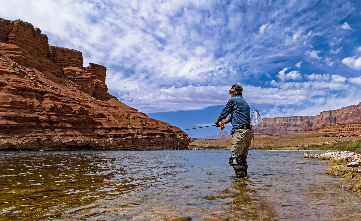 An angler casting a fly line in a river