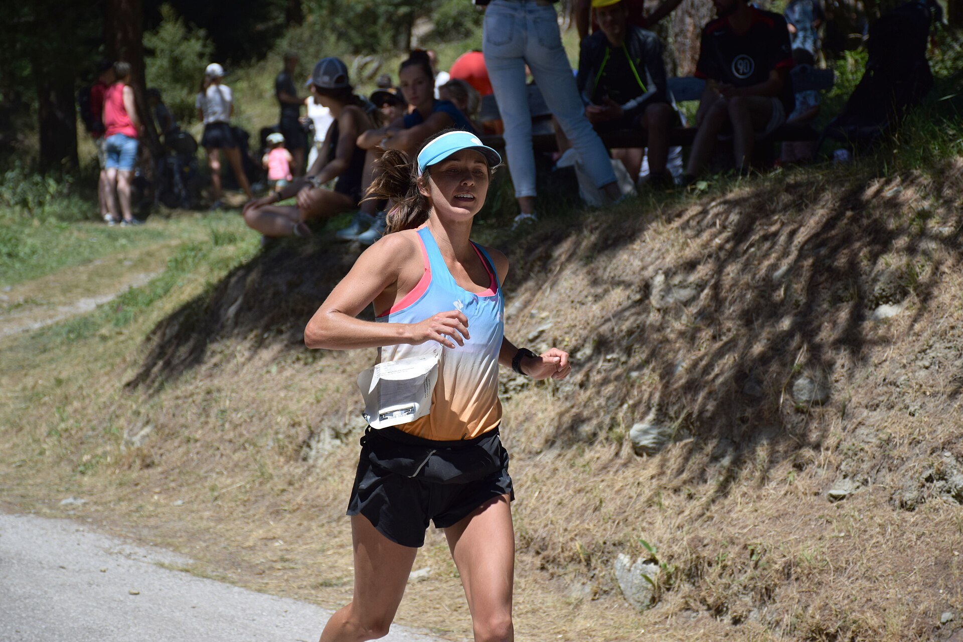 A trail runner mid-race on a mountain course